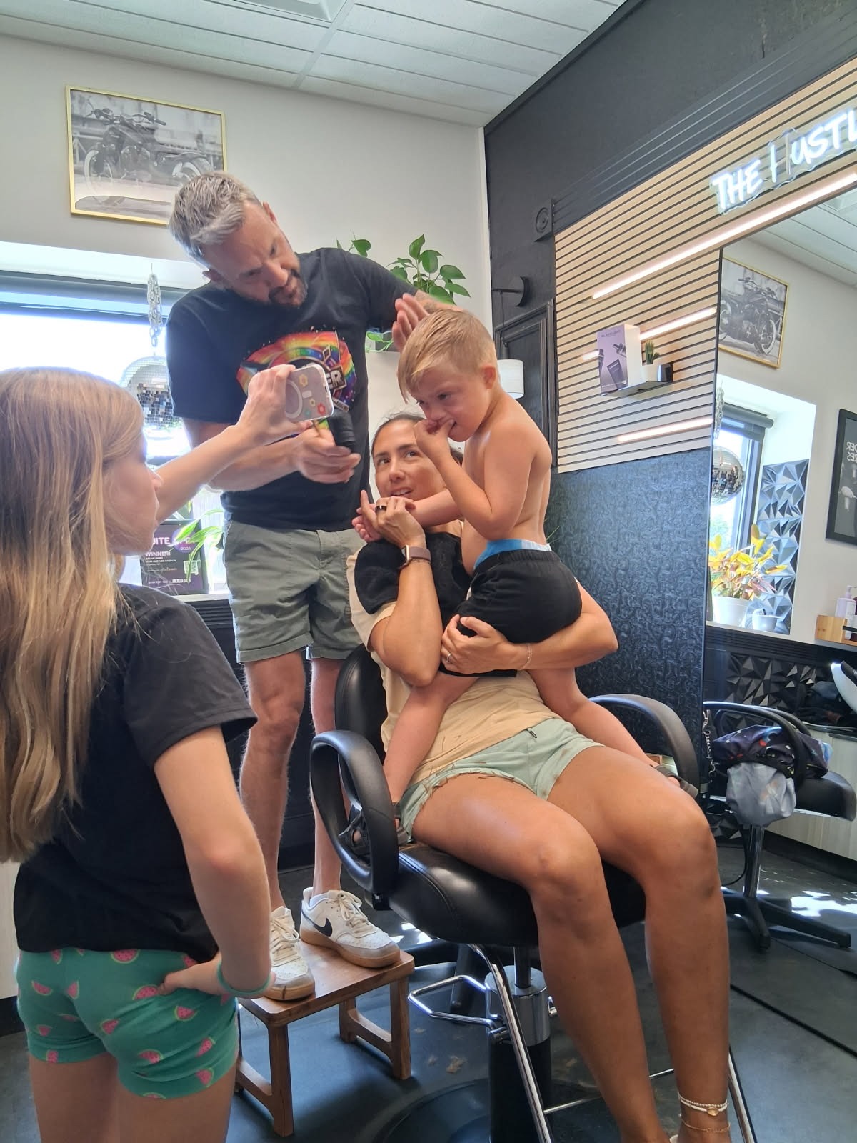 Brian with a young client and family at Hair Hustler Studios